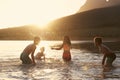 Children With Friends Enjoying Evening Swim In Countryside Lake Royalty Free Stock Photo