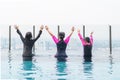 Children friendship concept with happy girl kid group having fun playing together in swimming pool on rooftop hotel