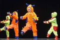 Children in funny colored overalls aliens dancing on stage