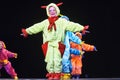 Children in funny colored overalls aliens dancing on stage