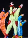 Children in funny colored overalls aliens dancing on stage