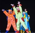 Children in funny colored overalls aliens dancing on stage Royalty Free Stock Photo