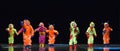 Children in funny colored overalls aliens dancing on stage