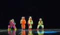 Children in funny colored overalls aliens dancing on stage