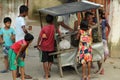 Children are gathered around a local pickle seller vehicle or selling cart at barasat, kolkata.