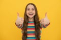 Children gesture. Happy teenager kid girl in casual clothes showing thumbs up. Excited face, cheerful emotions of Royalty Free Stock Photo