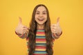 Children gesture. Happy teenager kid girl in casual clothes showing thumbs up. Excited face, cheerful emotions of Royalty Free Stock Photo