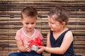 Children with gift box on wooden background Royalty Free Stock Photo