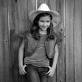 Children girl as kid cowgirl posing on wooden fence Royalty Free Stock Photo