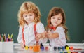 Children girl and boy drawing with coloring pens. Cute school kids painting in class at school. Painting lesson, drawing Royalty Free Stock Photo