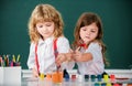 Children girl and boy drawing with coloring pens. Cute school kids painting in class at school. Painting lesson, drawing Royalty Free Stock Photo