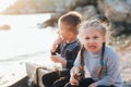 Children , girl and boy eat chicken meat on the sea, girl is angry and does not want to Royalty Free Stock Photo