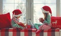 Children girl and boy in pajamas is sad on Christmas morning by window Royalty Free Stock Photo