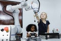 Children girl caucasoid and girl African American education electronic robotic arm on table at class room. learning innovation