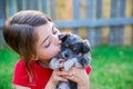 Children girl kissing her puppy chihuahua doggy Royalty Free Stock Photo