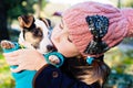 Children girl kissing her puppy terrier doggy on the park Royalty Free Stock Photo