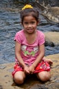 Children girl Laotian people sitting for take photo on the rock