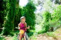 Children girl riding bicycle in forest smiling Royalty Free Stock Photo