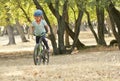 Children girl riding bicycle in forest Royalty Free Stock Photo