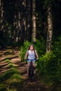 Children girl riding bicycle outdoor in forest smiling. Royalty Free Stock Photo