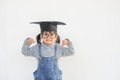 Children girl wearing a graduate cap over white background very happy and excited doing winner gesture with arms raised, smiling Royalty Free Stock Photo