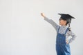 Children girl wearing a graduate cap over white background very happy and excited doing winner gesture with arms raised, smiling Royalty Free Stock Photo