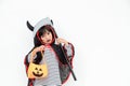 Children girl wearing mysterious Halloween dress holding a scary pumpkin and sickle