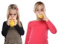 Children girls kids drinking orange juice healthy eating portrait format isolated on white