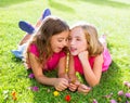 Children girls playing whispering on flowers grass