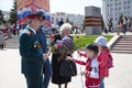 Children give flowers to veterans