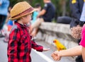 Children give a food for a bird in the park