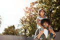 Children give us a million reasons to smile. a father giving his little son a piggyback ride outdoors. Royalty Free Stock Photo