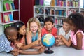 Children with globe on table Royalty Free Stock Photo