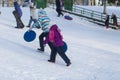 Children go sledding in winter .Winter entertainment and recreation