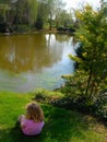 Children on grass by lake