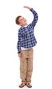 Children, growth and mockup with a boy measuring his height in studio isolated on a white background. Kids, hand and Royalty Free Stock Photo