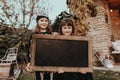 Children in Halloween costumes in front of an old house Royalty Free Stock Photo
