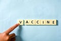 Children hand completing vaccine word on the puzzle