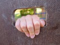 Children hand holds a hole on the wooden climbing wall. Short fingers hold through ladder Royalty Free Stock Photo