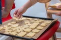 Children hand laying cookie on a baking tray