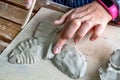 Children hand sculpts clay crafts in pottery school