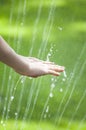 Children hand water drop grass background