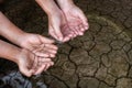 Children hands on the arid soil. Royalty Free Stock Photo