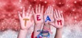 Children Hands Building Word Team, Red Christmas Background Royalty Free Stock Photo