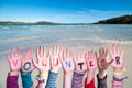 Children Hands Building Word Volunteer, Ocean Background Royalty Free Stock Photo
