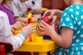 Children hands building towers out of wooden bricks