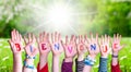 Children Hands Building Word Bienvenue Means Welcome, Grass Meadow