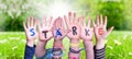 Children Hands Building Word Staerke Means Strength, Grass Meadow