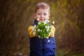 Children hands holding bouquet spring flowers. Focus on hand wi Royalty Free Stock Photo