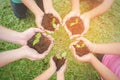 Children hands holding sapling in soil surface with plant Royalty Free Stock Photo